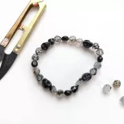 Cuenta plana de calavera 10x8 mm imitación Howlite teintée - Noir x1