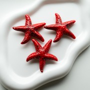 Colgante estrella de mar, 49x45 mm, acrílico - Rojo - Negro jaspeado x1