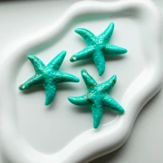 Colgante acrílico estrella de mar 49x45 mm - Turquesa - Marrón jaspeado x1