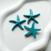 Colgante estrella de mar 37x38 mm resina - Azul turquesa - Negro jaspeado x1