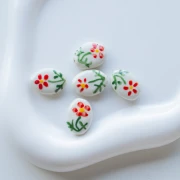 Cuenta cerámica oval 19,5x14,5 mm - Motivo flor - Blanco - Rojo - Verde x1
