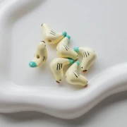 Cuenta de cerámica pájaro 15x21 mm - Beige - Turquesa x1